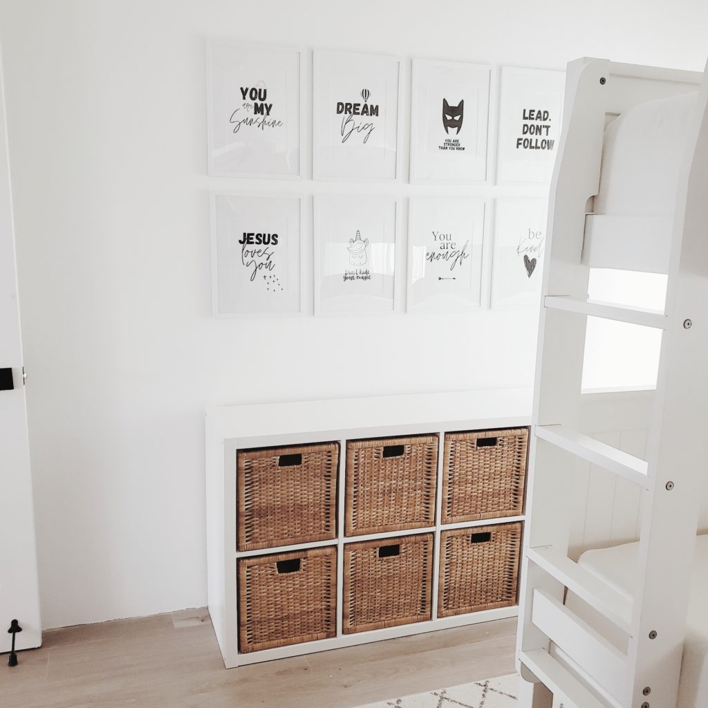 after picture showing 8 black and white framed motivational kids artwork above a white book shelf