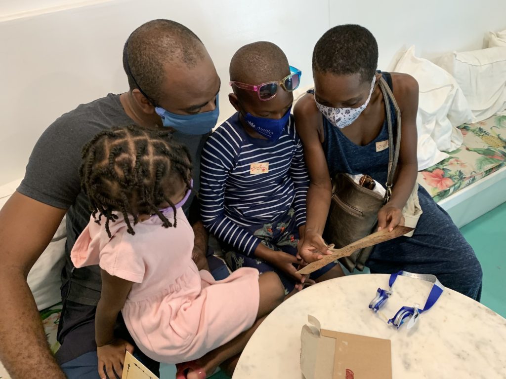 black family reading first clue in a coffee shop