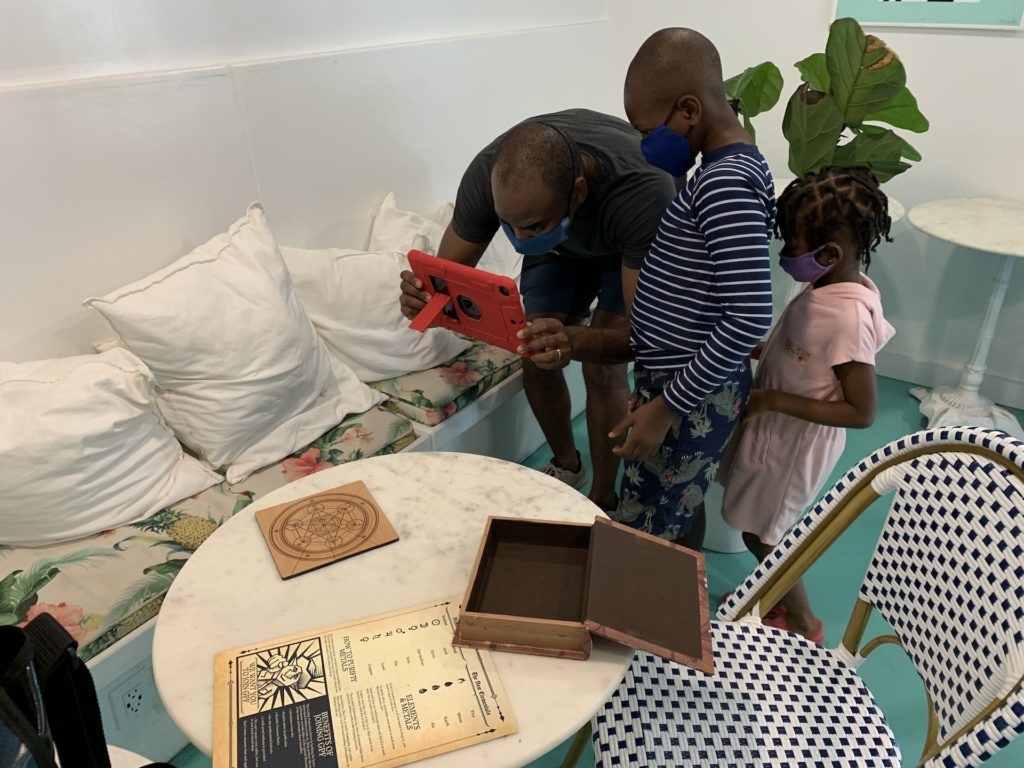 Black family looking for treasure hunt clues with ipad