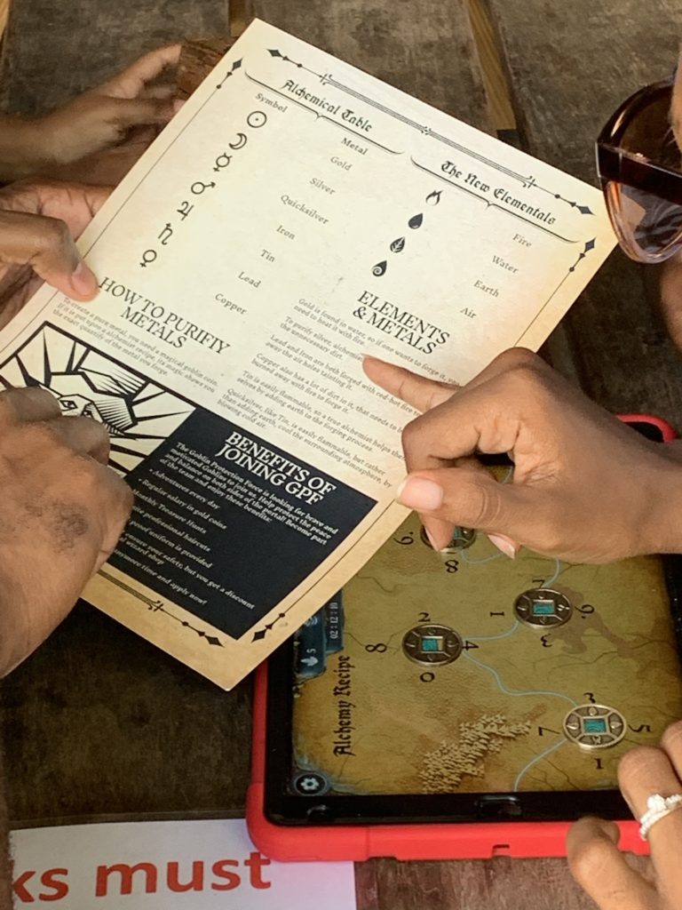 family looking at newsletter to solve clues