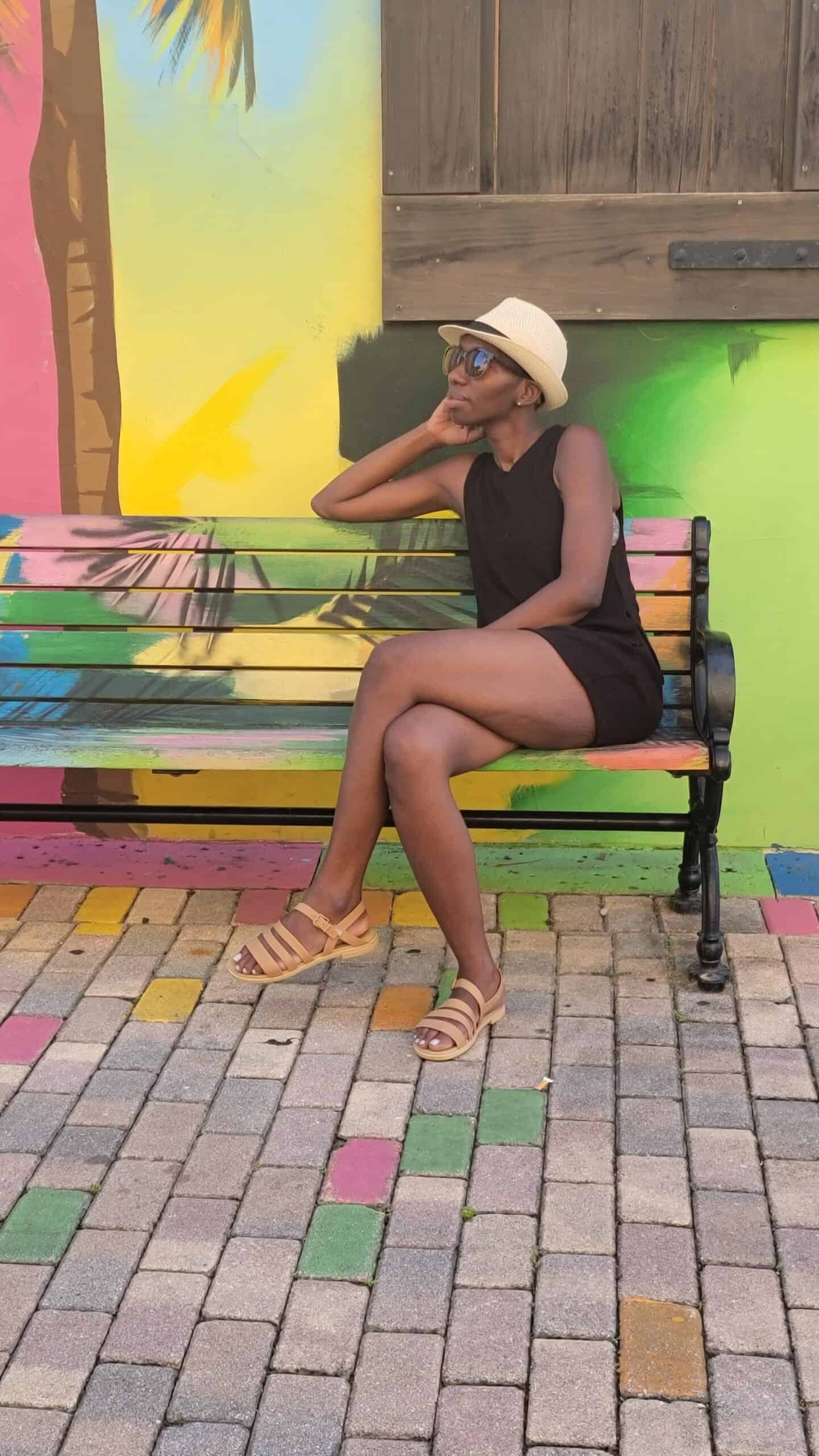 black woman sitting on bench happy she is learning to trust herself